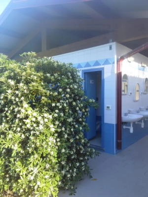 Entrances to the showers of the first block of services at Camping Rada Etrusca in Tuscany